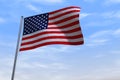 CGI isolated USA flag waving on a blue sly - close up of United States of America national flag flowing in the wind in US American
