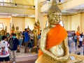 Many people pray respect Golden Buddha statue inside