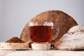 Chaga tea - a strong antioxidant, boosts immune system, has detox quality, improves digestive. Healthy drink in a clear cup next