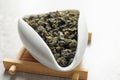 Chahe of Tie Guan Yin oolong tea leaves on light background