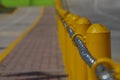 Chain along a yellow post line on a street Royalty Free Stock Photo