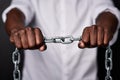 Chain, black background and hands in fist with link together for strong connection, freedom and bondage. Black man