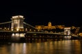 Chain bridge Budapest Hungary illuminated at night with old palace in the background Royalty Free Stock Photo