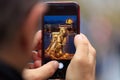 Chain Bridge in Budapest picture appears on tablet, smartphone in man`s hands. Blurred background Royalty Free Stock Photo