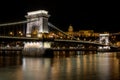 The Chain Bridge with the Royal Palace in the background in Budapest at night Royalty Free Stock Photo