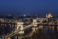 Chain bridge Szechenyi Bridge , danube palace and st Stephen`s basilica at dusk, Budapest, Hungary Royalty Free Stock Photo
