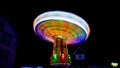 Chain carousel at a funfair by night in motion blur