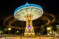 chain carousel ride in amusement park at night