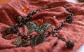 Chain with decorative leaves, beads, butterflies on red cloch