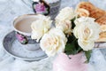 Chain drinking hot tea on a wooden floor with beautiful roses. Royalty Free Stock Photo