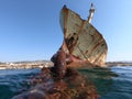 Chain emerging from the water facing the ship