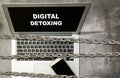 Chain fence locking smartphone and laptop with Digital Detoxing text