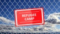 Chain fence with red sign Refugee camp