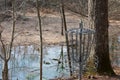 A Chain Frisbee Golf Hole in a Winter Forest With a Pond in the Background Royalty Free Stock Photo