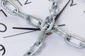 Chain holding an alarm wall clock, time management concept Royalty Free Stock Photo