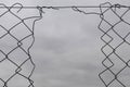 Chain link fence with hole damage wire background Royalty Free Stock Photo