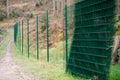 Chain link fence, metal wire., grid construction, building an enclosure for animals in the forest, protect wildlife and nature Royalty Free Stock Photo