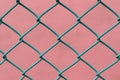 Details of a Chain Link Fence with pink Background. Royalty Free Stock Photo