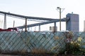 Chain link fence with privacy slats separating the street from the inside of an industrial facility Royalty Free Stock Photo