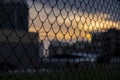 Chain link fence on a sunset background Royalty Free Stock Photo