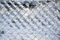 Chain link fence from wire mesh covered with snow, abstract winter texture background, concept for weather, nature and season, Royalty Free Stock Photo