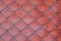 Chain link fencing mesh and red rusty metal background. Royalty Free Stock Photo