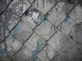 Chain link mesh on a gray painted background - vandal-proof protection of municipal and departmental property. no graffiti