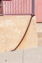 Chain links at the bottom of a railing near the concrete wall in San Francisco, California Royalty Free Stock Photo