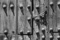 Chain lock on old wooden door with round rivets Royalty Free Stock Photo