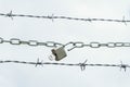 chain with padlock on barbed wire Royalty Free Stock Photo