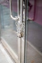 Chain and padlock on closed business glass door with metal handles Royalty Free Stock Photo