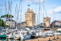 The Chain and Saint Nicolas towers of La Rochelle in middle of sailing boats of the old port of La Rochelle France