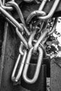 A chain of silver color with closed padlock on an old gate. Royalty Free Stock Photo