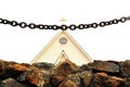 Chain and stone wall in front of church Royalty Free Stock Photo