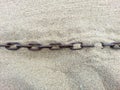 Chain sunk in the sand