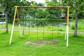 Chain swing in the park. Empty chain swing at the playground with grass