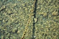 Chain in water, stones, water, abstract background Royalty Free Stock Photo