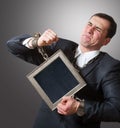 Chained businessman with a board