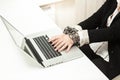 Chained businesswoman typing on keyboard