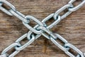 Chains crossed on the wooden background