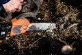 Chainsaw in action cutting wood. unrecognizable Man cutting wood with saw, dust and movements. Chainsaw. Close-up of woodcutter Royalty Free Stock Photo