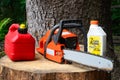 Chainsaw and canister of gasoline and motor oil