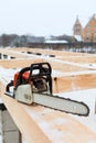 Chainsaw carpenter tool for building a frame house at winter season