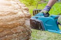 Chainsaw. Chainsaw in move cutting wood. Man cutting wood with saw. Dust and movements. Close-up of woodcutter sawing chain saw. B Royalty Free Stock Photo