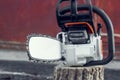 Chainsaw on a stump on the street background Royalty Free Stock Photo