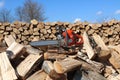 Chainsaw on top of wood pile on a sunny day