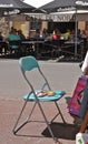 Chair and artist`s pallet in a French market