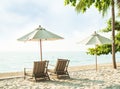 Chair Beach and Umbrella on Sand at Coast with blur Blue Sea and Cloud Sky Background Tropic Ocean Island Paradise with Sunny Royalty Free Stock Photo