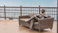 Chair and bronze statue on Navy pier Chicago - CHICAGO, USA - JUNE 11, 2019 Royalty Free Stock Photo