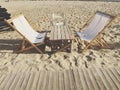 Chair, deck chair and table on the sand Royalty Free Stock Photo